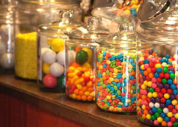 Old fashioned candy store with large jars of candy on the counter.